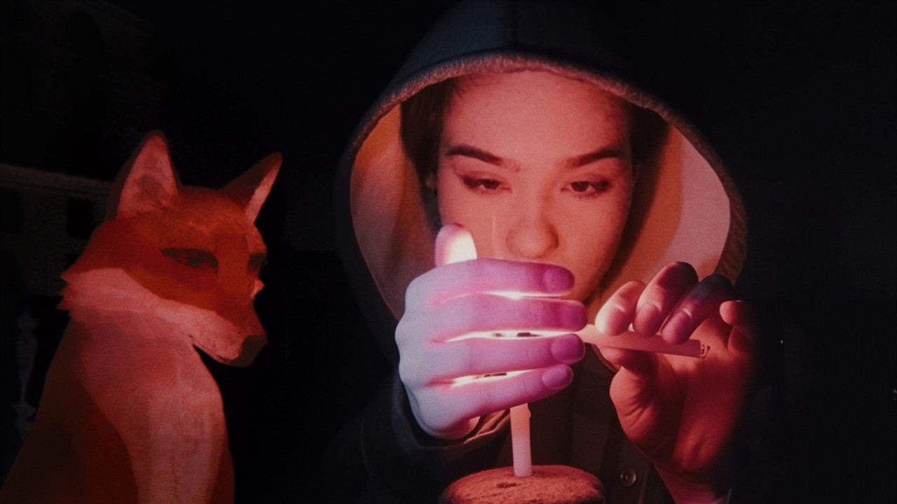 Soraya lights a birthday candle, drawn fox watches